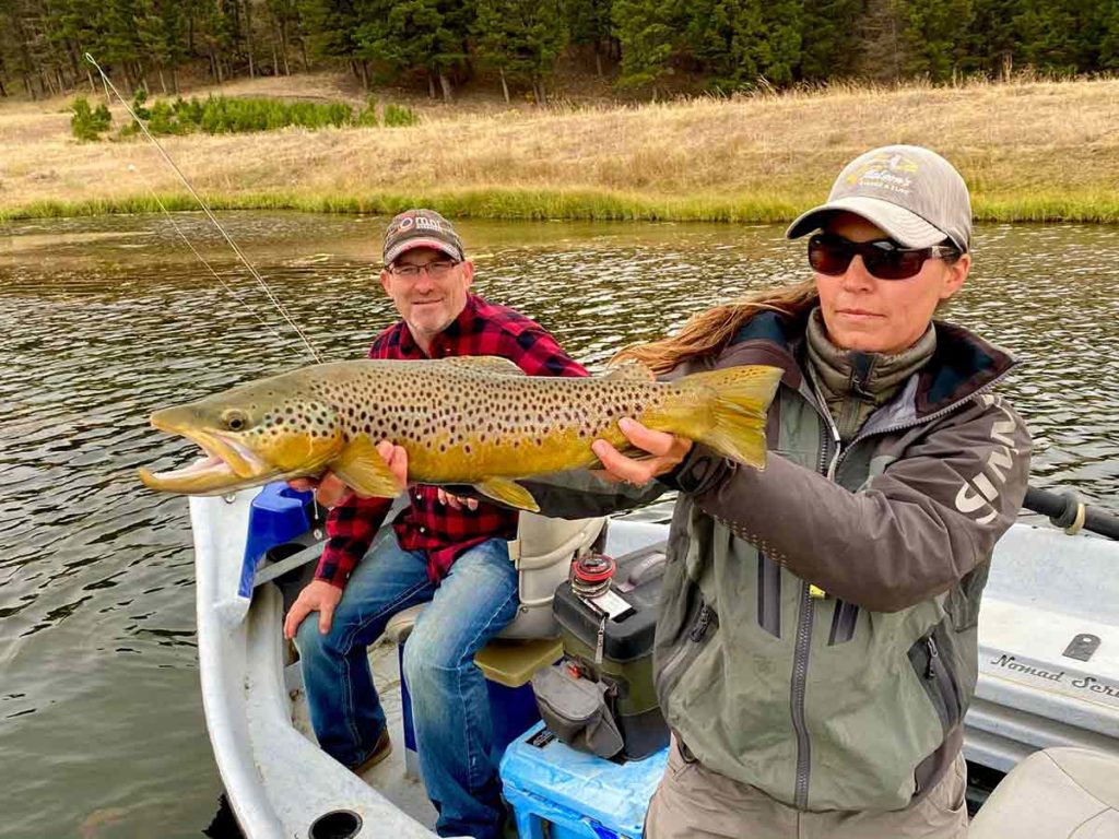 Jacquie Nelson, owner and river fishing guide with Nelson's Guides and Flies, shows off a fish caught while stillwater fly fishing.